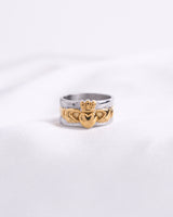 Two-tone ring with gold heart and crown design on a white background